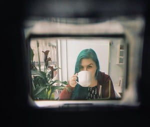 Arty picture of young woman drinking coffee.