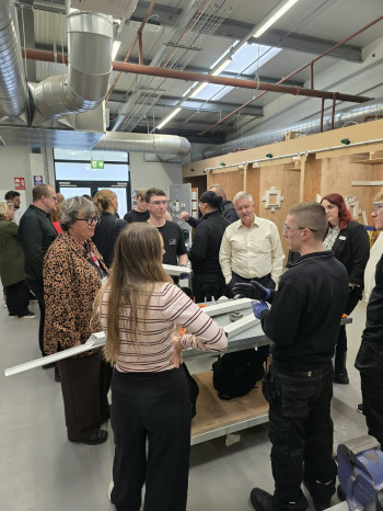 Group speaking to apprentice and workers in the workplace